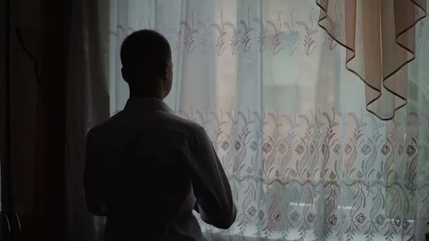 Young man admire view from window at home and put on a shirt. Slow motion Stock Footage 95991045
