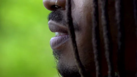 Young Man With African Locks Smiling Then Looking Serious Close Up Face Profile Stock Footage 142012127
