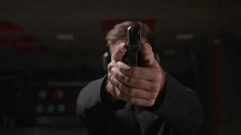 Young Man Aiming Pistol during Training in Shooting Club Stock Footage 311041059