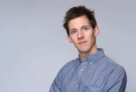 Young man alone on gray background Stock Photos