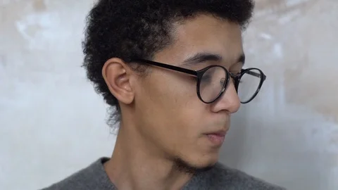Young man alone isolated on white in eyeglasses face close-up smiling calm Stock Footage 121646374