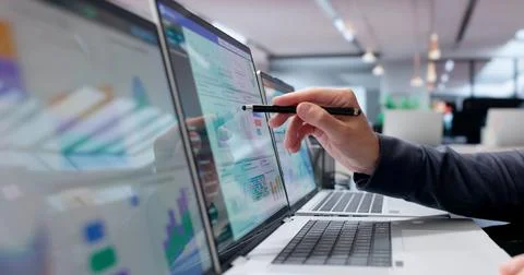 Young Man Analyzes Financial Data On Laptop To Track Business Performance. Stock Photos