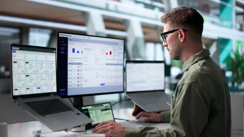 Young Man Analyzes SaaS Billing Data On Laptop Stock Footage 339888612
