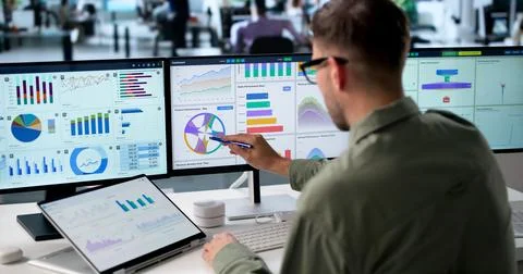 Young Man Analyzing Financial Data On Laptop, Monitoring Market Trends Closel Stock Photos