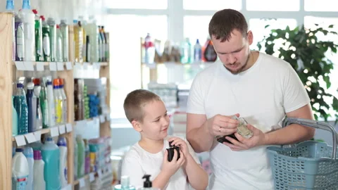 Young man and boy choosing perfume in store Stock-Footage 310320064