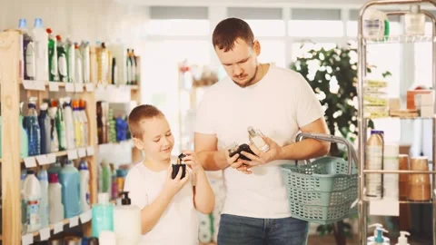 Young man and boy choosing perfume in store Stock-Footage 323069938