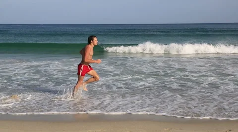 Young man and a boy running along the beach. Stock-Footage 28697408