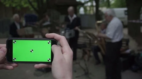 A young man and a green screen smartphone Stock Footage 76044167