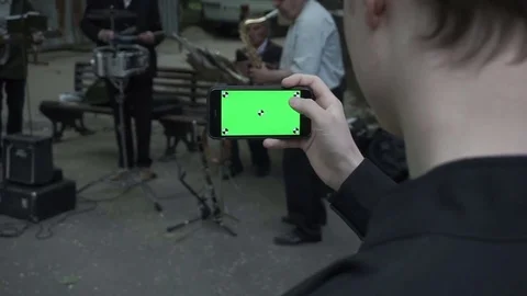 A young man and a green screen smartphone Stock Footage 76044280