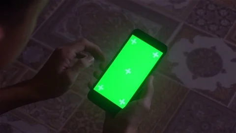 A young man and a green screen smartphone Video stock 82140478
