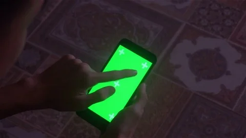 A young man and a green screen smartphone Stockbeeldmateriaal 82141255