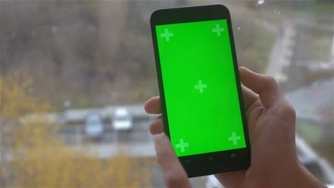 A young man and a green screen smartphone Stock Footage 82148549