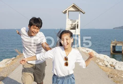 Young Man And Pretty Woman Joyful Emotion And Playing At Sea Side Vacation An