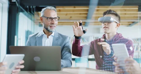 Young Man And Teacher Performing Interactive VR Lesson In A High Tech Classroom Stock Footage 100733318