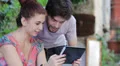 young man and woman are having fun looking at photos with your tablet HD Footage