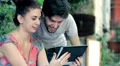 young man and woman are having fun surfing the internet with tablet HD Footage