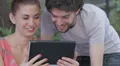 young man and woman having fun using webcam of a tablet HD Footage