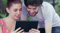 young man and woman having fun using webcam of a tablet computer HD Footage