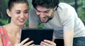 young man and woman having fun using webcam of a tablet computer HD Footage