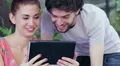 young man and woman having fun using webcam of a tablet computer HD Footage