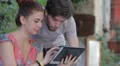 young man and woman having fun using a tablet HD Footage