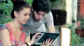 young man and woman having fun using a tablet HD Footage