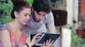 young man and woman having fun using a tablet HD Footage