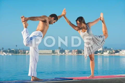 Young Man And Woman Practicing Yoga Position At Pacific Beach, San Diego,