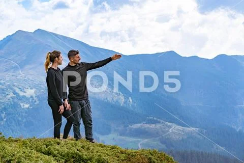 The young man and a woman standing on the mountain Stock Photos
