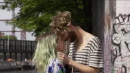 Young Man And Young Woman Kissing Beside A Canal In The City  Stock Footage