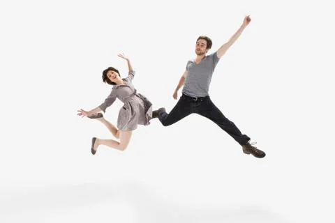 A young man and a young woman jumping mid-air Stock Photos