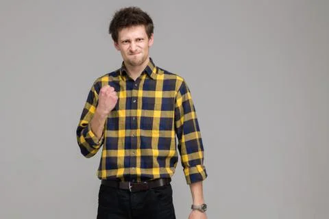 Young Man is Angry in Isolation on a Gray Background Stock Photos