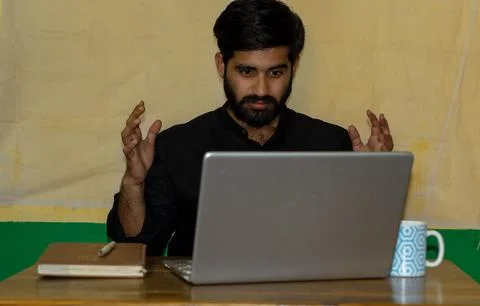Young man angry while looking at laptop Stock Photos