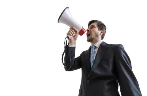 Young man is announcing a message and speaking to megaphone Foto stock