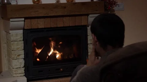 Young Man Answering A Call In Front Of A Fireplace Communication Concept Stock Footage 44015066