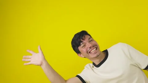 Young man appearing from the side to greeting his hand cheerfully on a yell.. Stock Footage 312234905