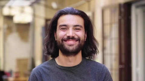 Young Man Appears Smiling Upwards from Bottom of Frame Stock Footage 287136391