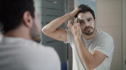 Young Man Applying Anti-aging Cream On Face For Skin Care Stock Footage 90731585