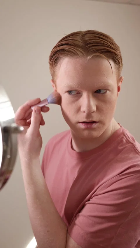 Young Man Applying Blush In Front Of A Ring Light Mirror Stock Footage 309904610