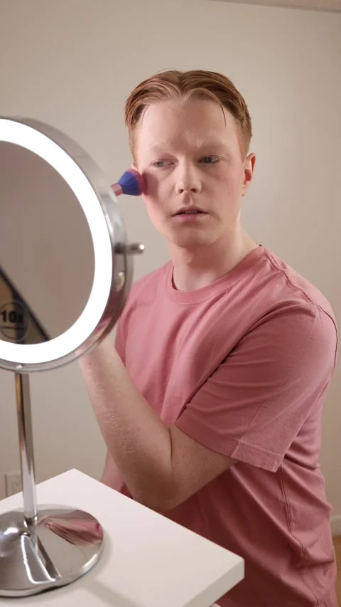 Young Man Applying Blush In Front Of A Ring Light Mirror Stock Footage 310152756