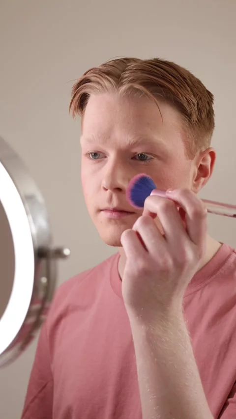 Young Man Applying Blush In Front Of A Ring Light Mirror Stock Footage 310152948