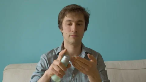 Young man applying cream on his face Stock Footage 131044490