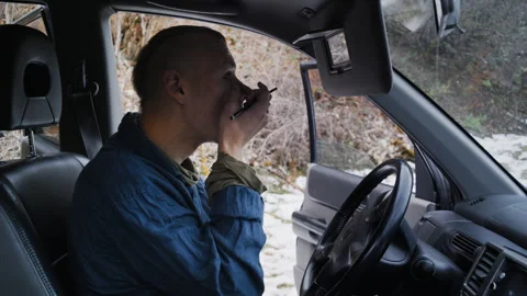 Young Man Applying Eye Makeup in Car During Winter Stock-Footage 302211293
