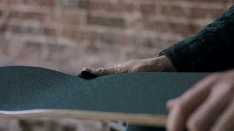 Young Man Applying New Grip Tape On His Skateboard Stock Footage 133623798