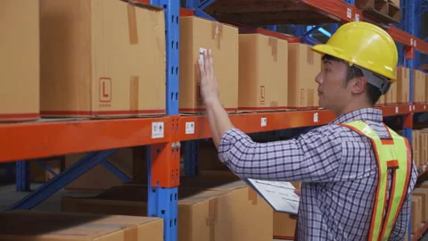 Young man applying shipping label to packaging or package and check document  Video stock 204825959