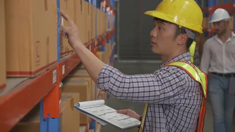 Young man applying shipping label to packaging and check document and manager Video stock 205974968