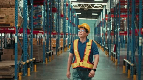 Young man Asian worker wearing helmet checking inventory and counting product 動画素材 204915513
