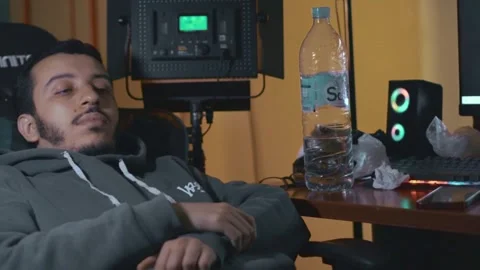 Young Man Asleep at Desk with Studio Lighting in Background Stock Footage 309770653