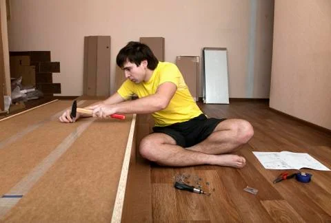 Young man assembling furniture Stock Photos