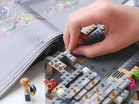 A young man assembling a lego set. Close up. Stock Photos